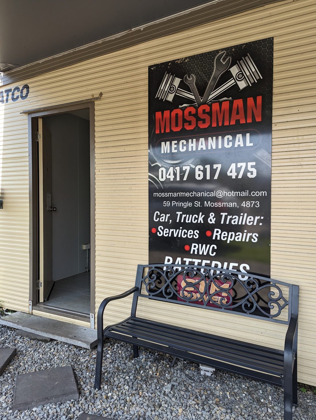 The Mossman Mechanical banner on the office wall showing the phone number, email address and the Pringle Street address